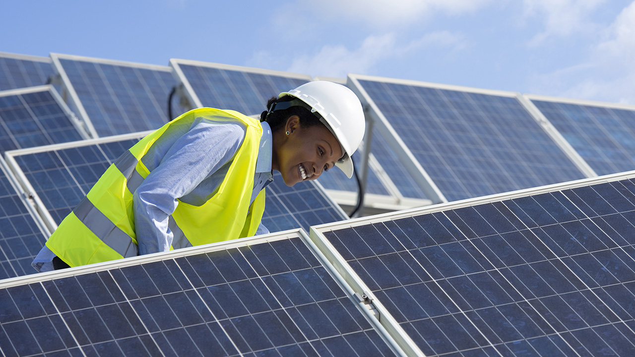 Worker in a large solar field